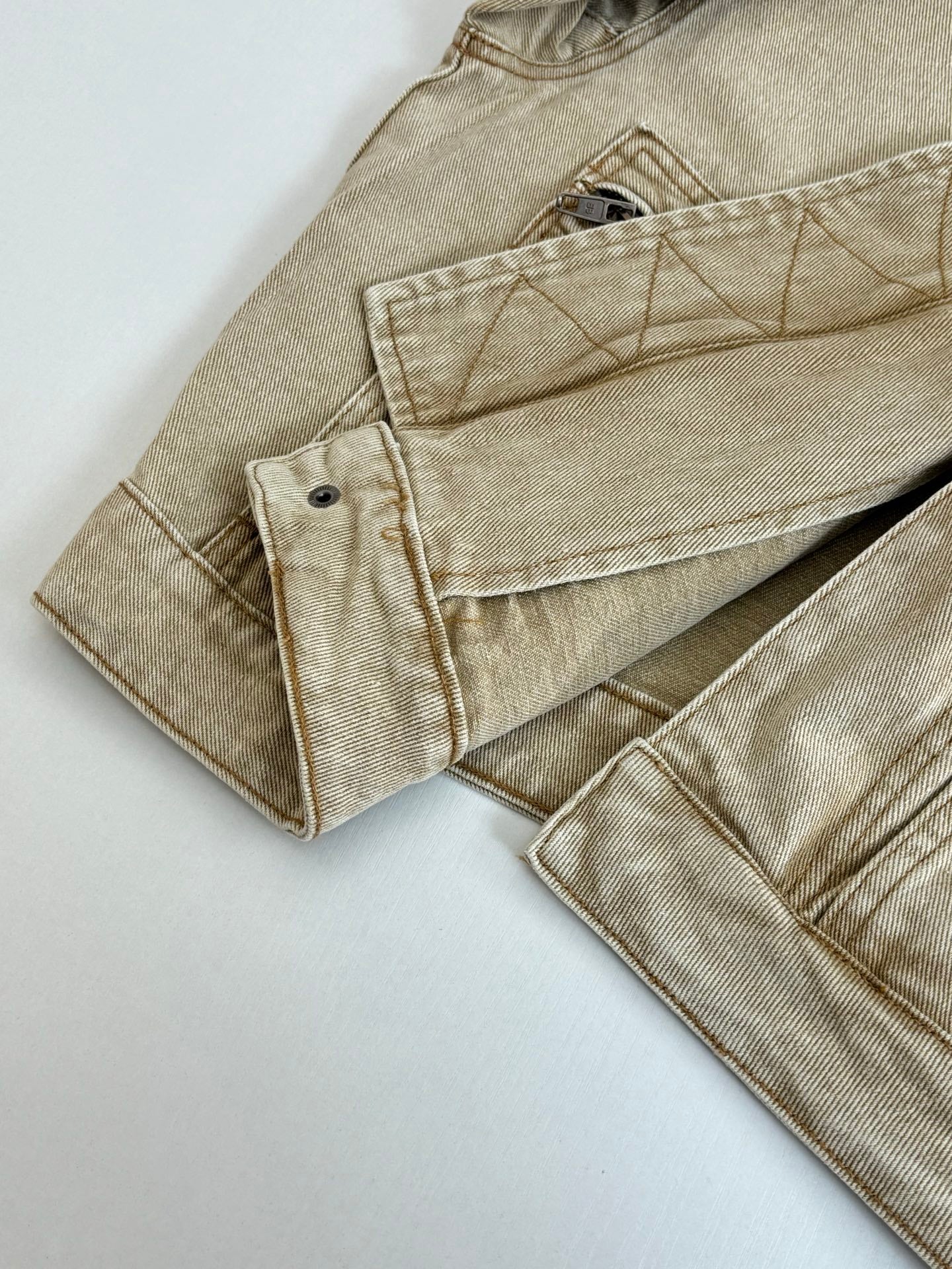 Beige jacket sleeve and hem with two patch pockets