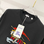 Black T-shirt with colorful horse rider graphic and hanging product tags