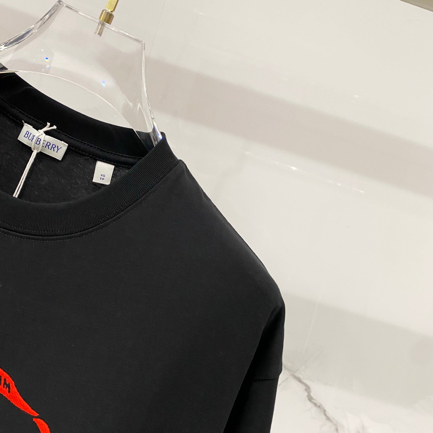 Black short-sleeve T-shirt with small internal Burberry label at neckline