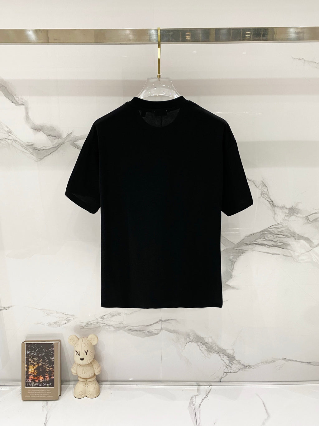 Black short-sleeve T-shirt on a hanger with crew neck
