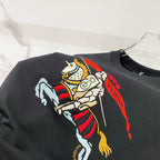 Black T-shirt close-up showing large colorful horse rider graphic on chest