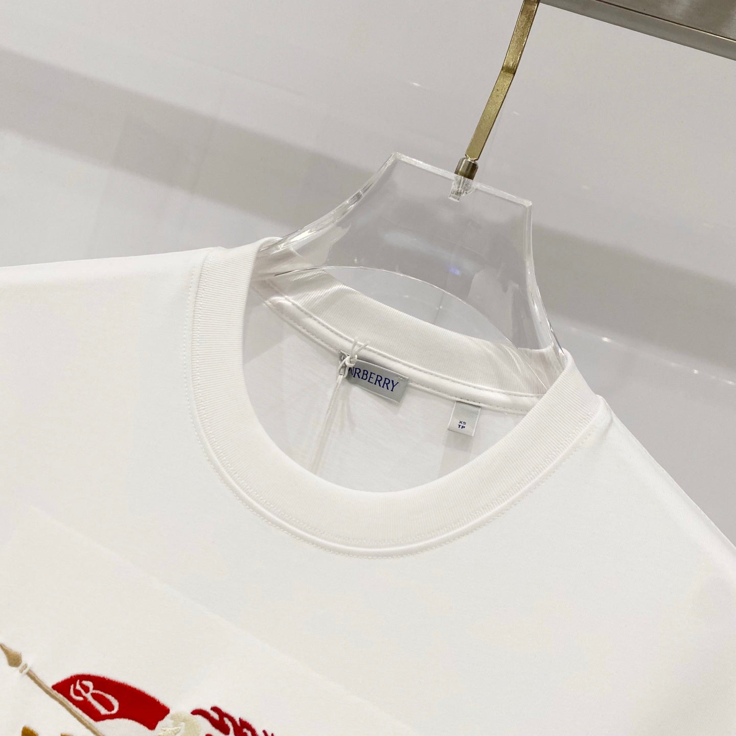 Burberry white crew-neck T-shirt neckline close-up with inner size tag
