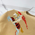 Tan T-shirt with large embroidered cartoon horse crest graphic on front