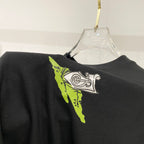 Black crewneck T-shirt with neon green and white logo-style print