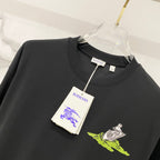 Black crewneck T-shirt with neon green and white graphic; Burberry tag attached
