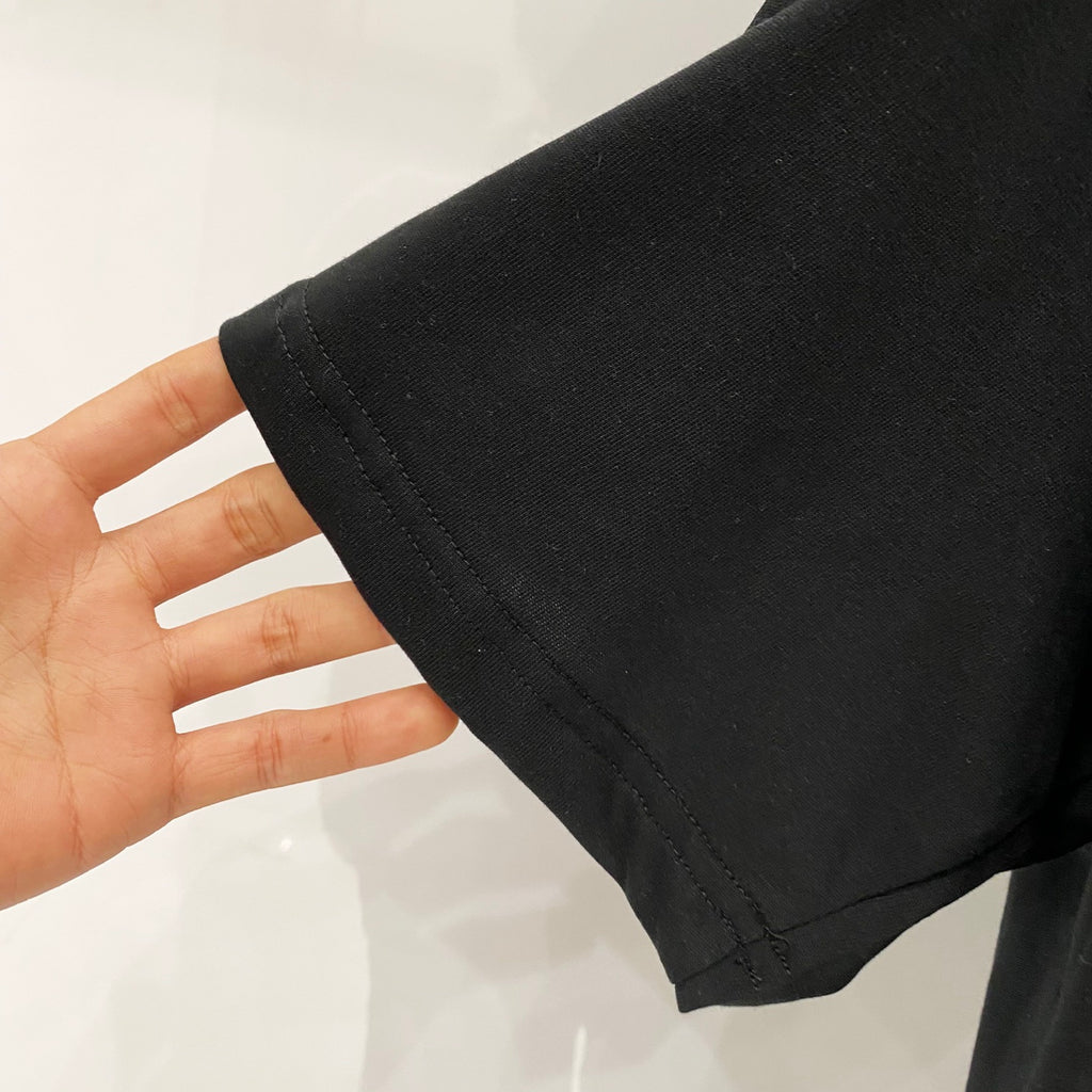 Black T-shirt sleeve hem with neat stitching