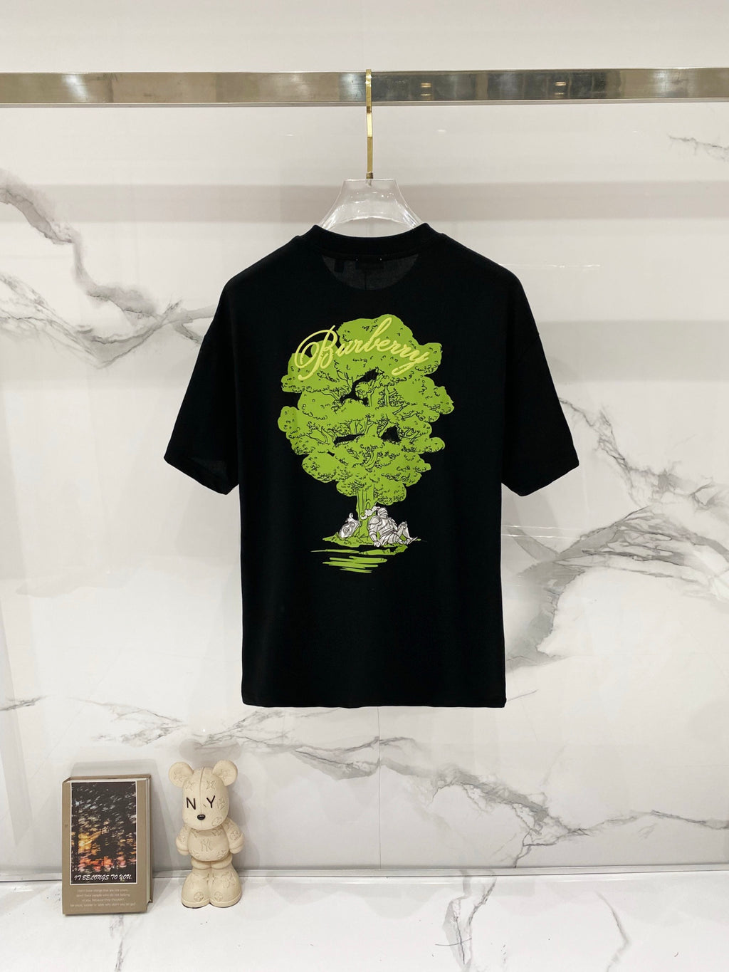 Black crewneck T-shirt with large neon green artwork graphic