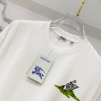 Burberry white crew-neck T-shirt with green graphic print and attached tag