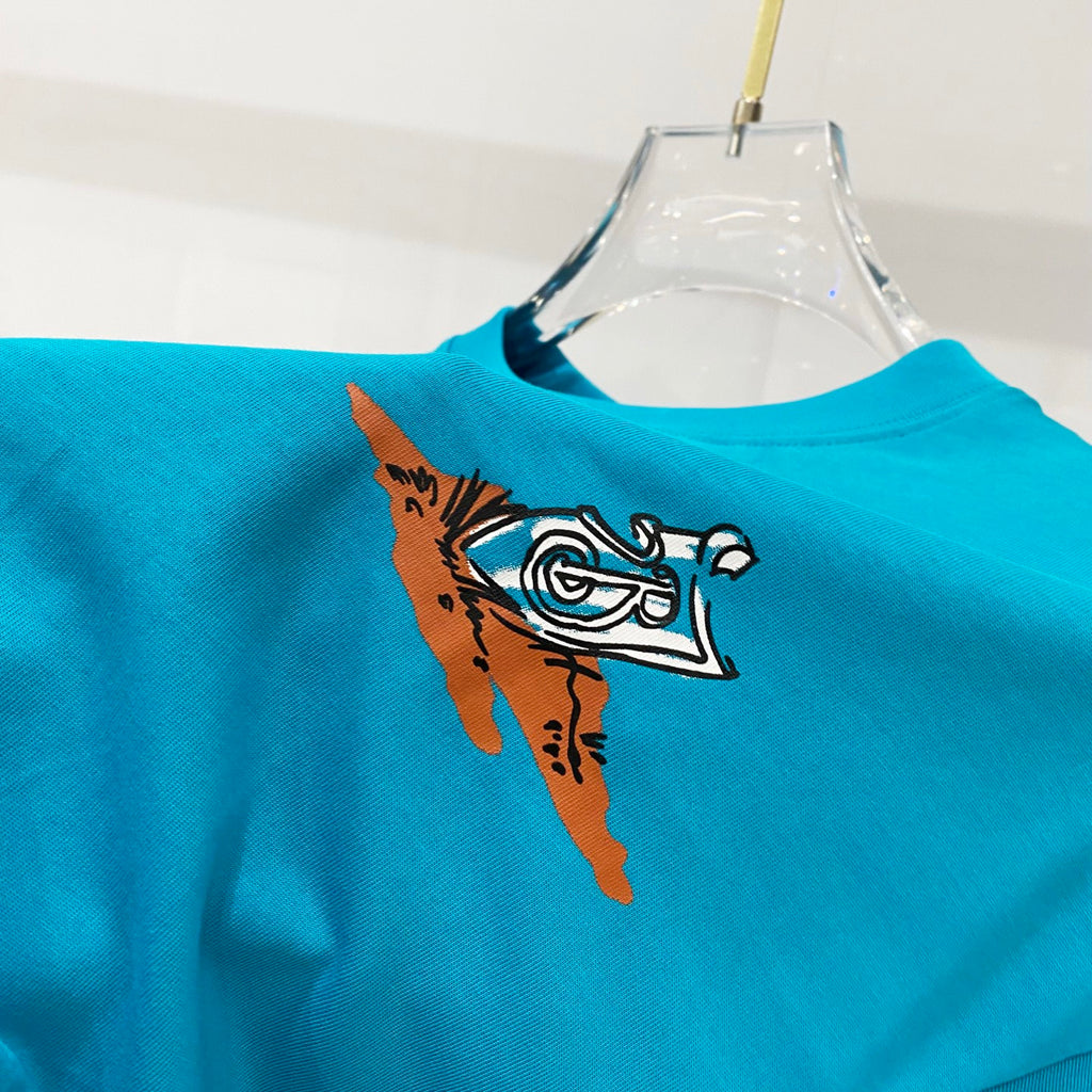 Turquoise T-shirt with illustrated bird graphic on the front