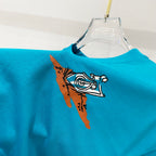 Turquoise T-shirt with illustrated bird graphic on the front