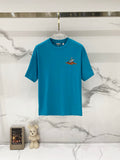 Turquoise short-sleeve T-shirt with small bird graphic on the chest
