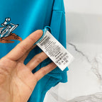 Turquoise T-shirt with Burberry care label on the inner side seam