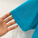Turquoise T-shirt sleeve hem with visible stitching