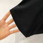 Black Burberry T-shirt fabric close-up at sleeve hem