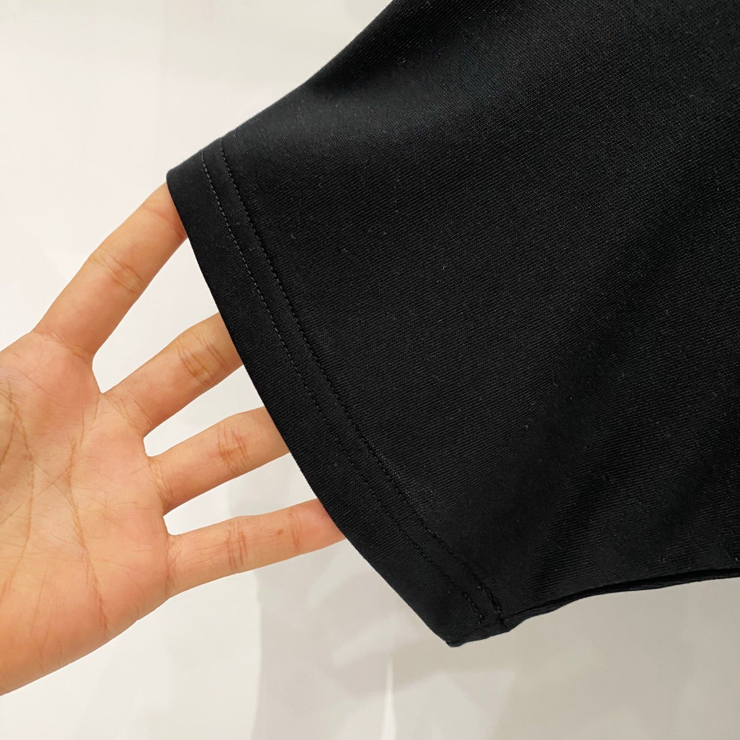 Black Burberry T-shirt fabric close-up at sleeve hem
