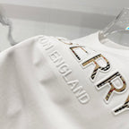 White T-shirt with embossed 'BURBERRY' lettering on shoulder/sleeve