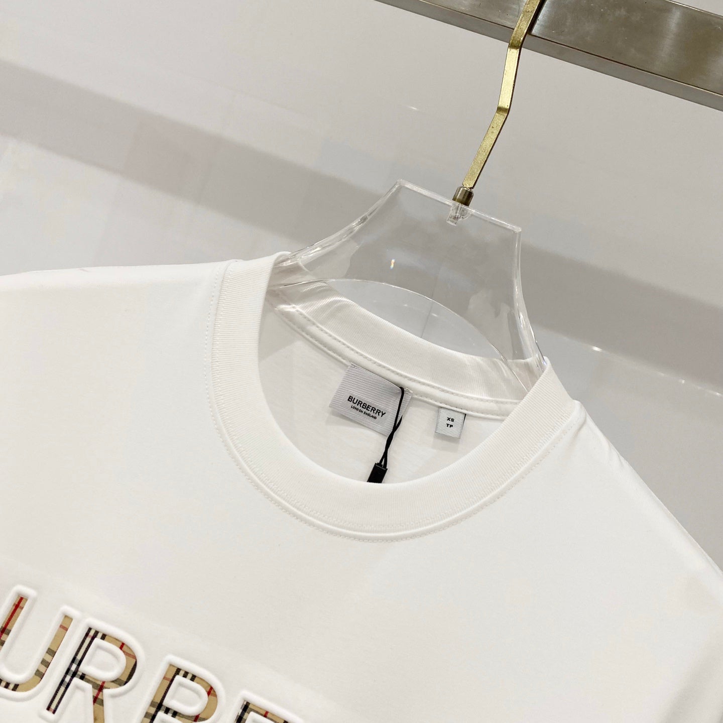 White crew-neck T-shirt neckline with Burberry label and inner size tag