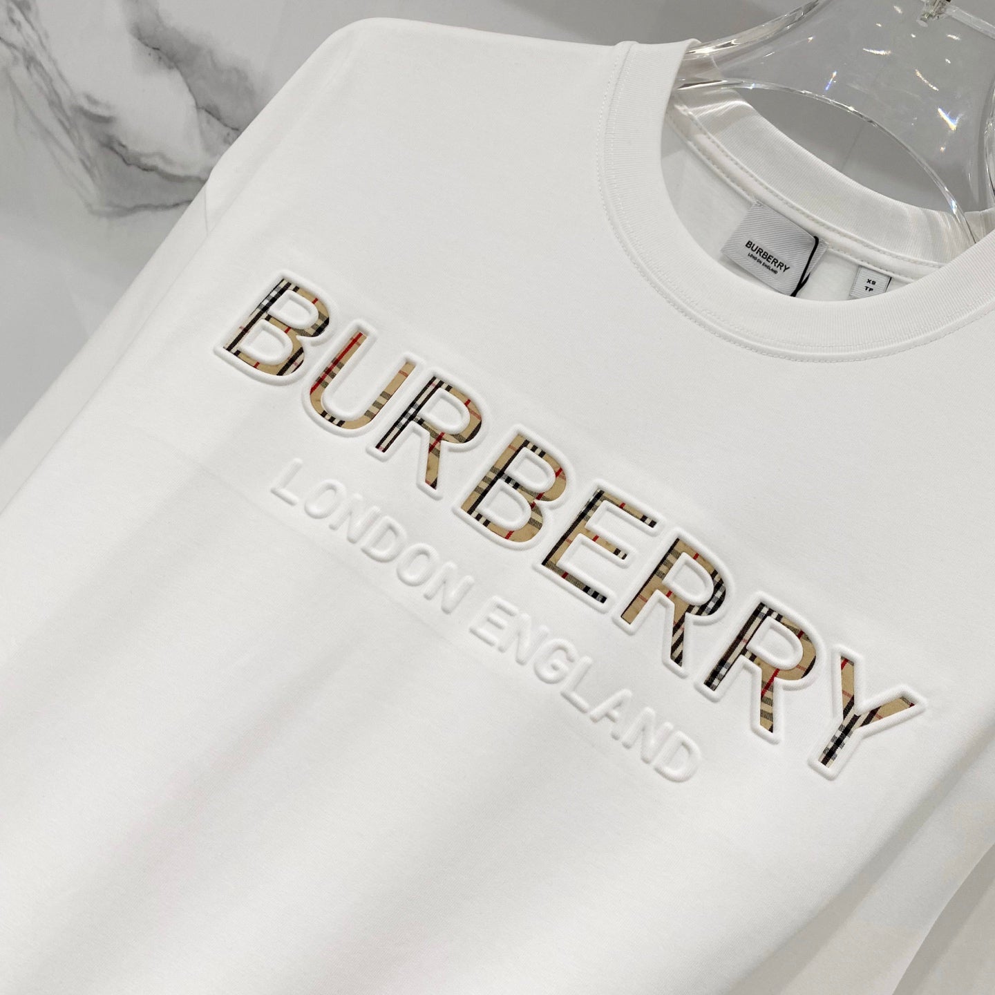 White Burberry T-shirt with raised 'BURBERRY' logo and 'LONDON ENGLAND' text