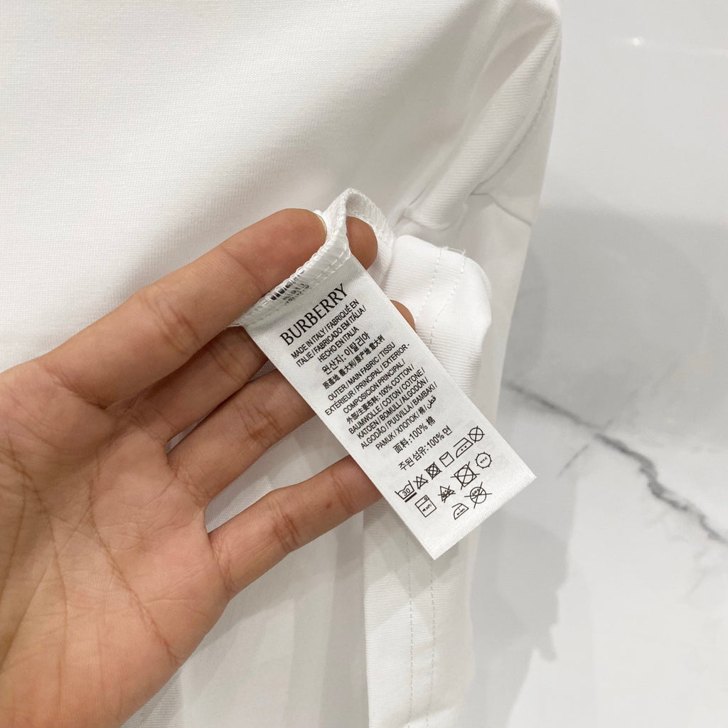 White T-shirt showing inner care label near the collar seam