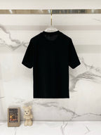Black crewneck T-shirt with gold logo embroidery on the chest