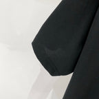 Black short-sleeve T-shirt hem and side seam close-up