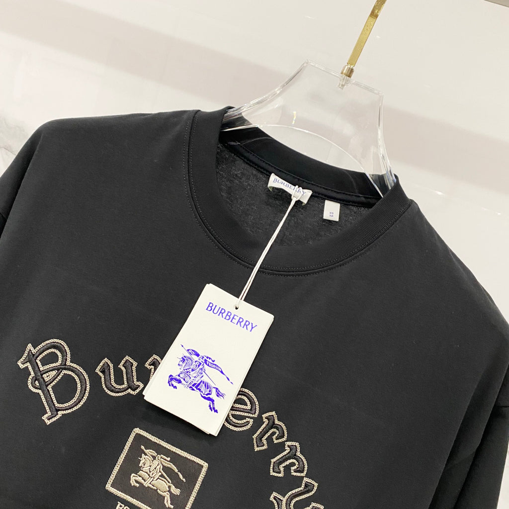 Black crewneck T-shirt with gold Burberry crest patch and script embroidery