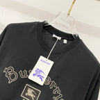 Black crewneck T-shirt with gold Burberry crest patch and script embroidery