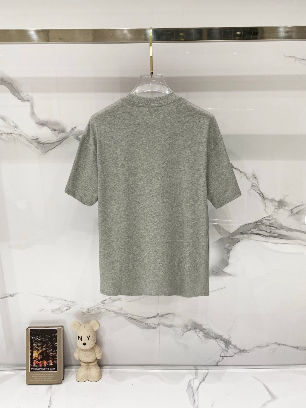 Grey short-sleeve T-shirt, back view on hanger