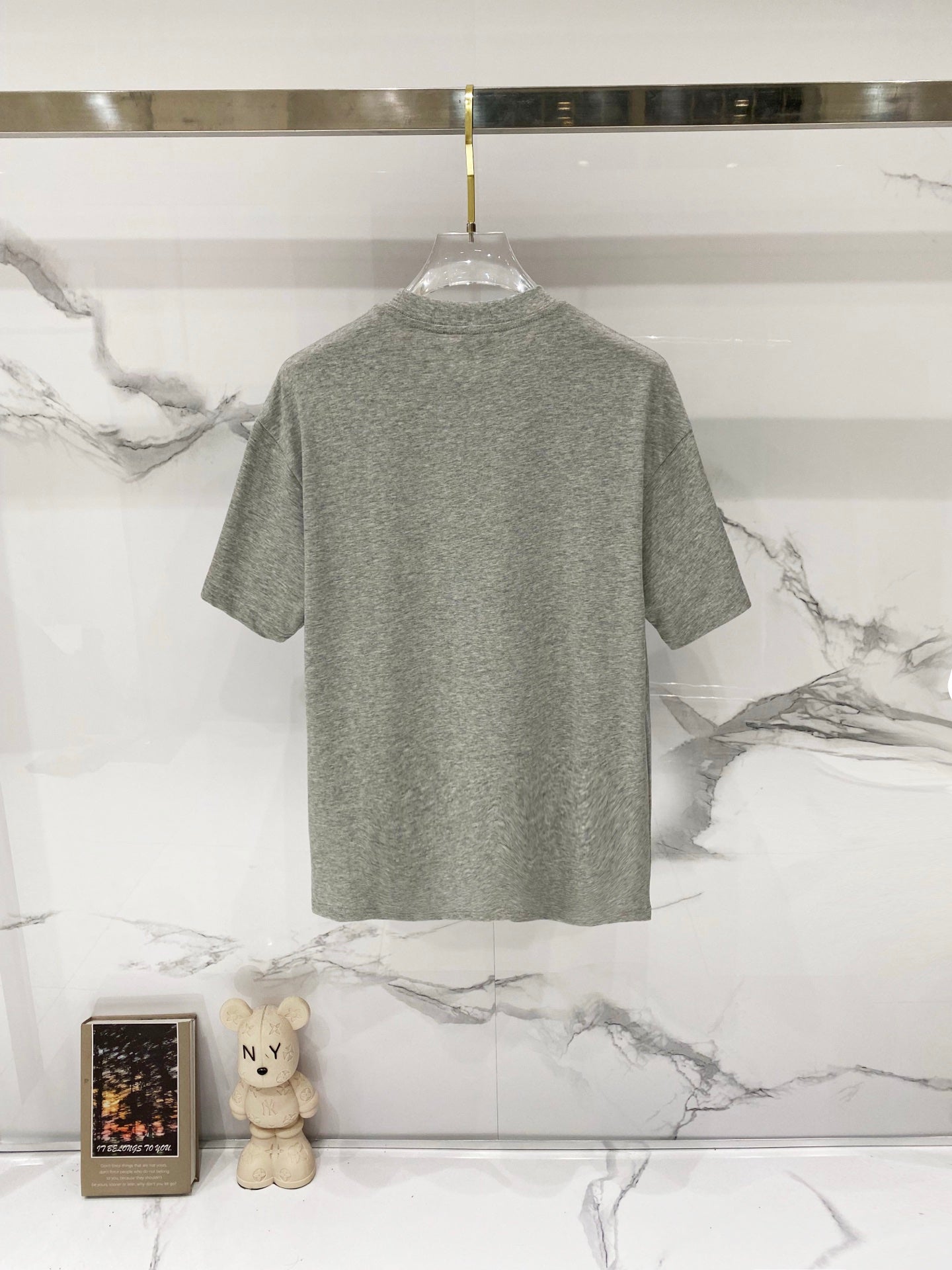 Grey short-sleeve T-shirt, back view on hanger