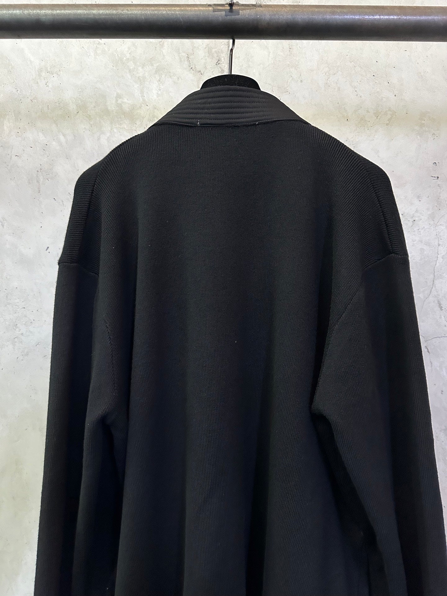 Black long coat back close-up with high collar and long sleeves