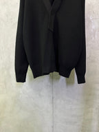 Black long coat front lower section with long sleeves and clean hemline