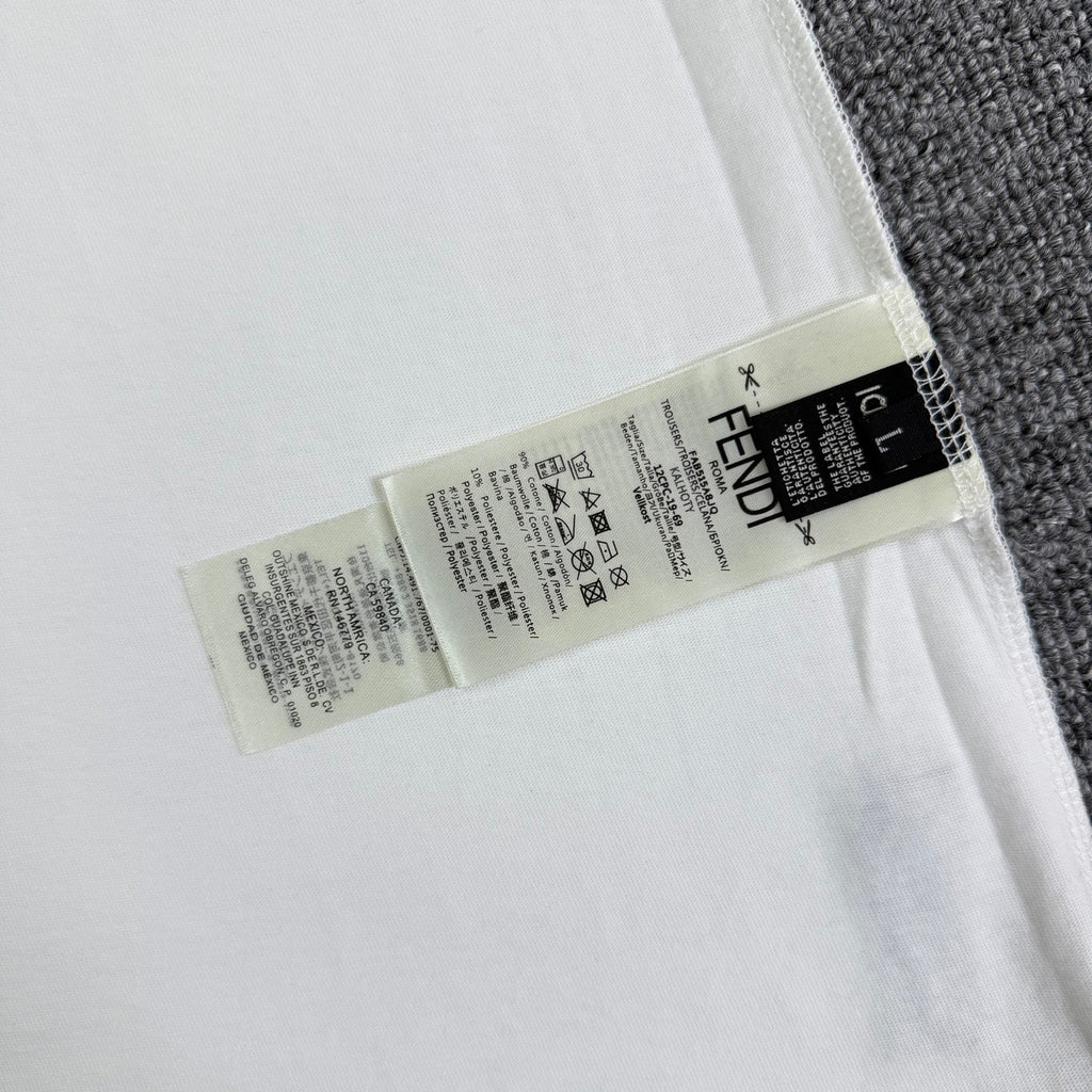White Fendi T-shirt closeup of inner care label on hem.