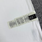 White Fendi T-shirt closeup of inner care label on hem.