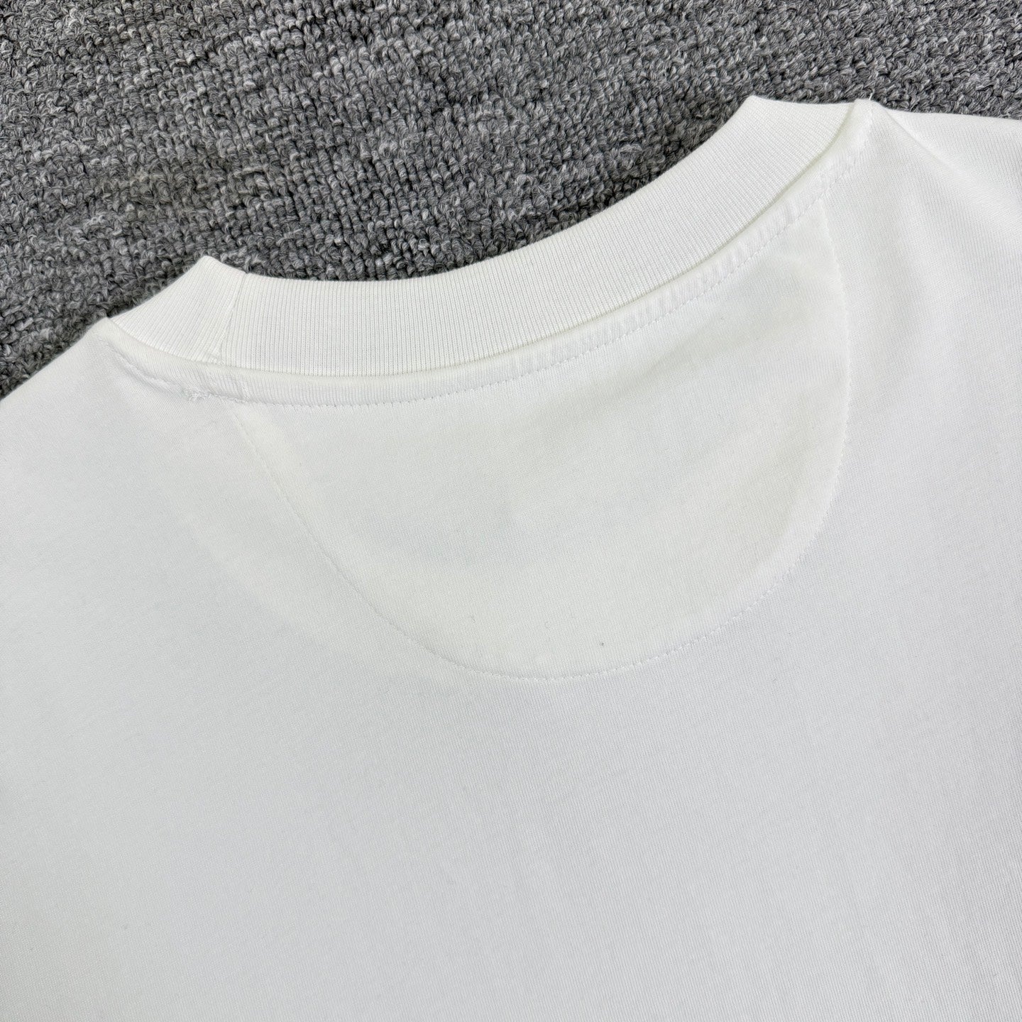 White Fendi T-shirt closeup: back yoke and crew neckline.