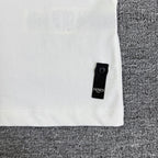 White Fendi T-shirt side hem with small black Fendi label tab.