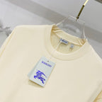 Pale yellow short-sleeve T-shirt with crew neck and hanging Burberry tag