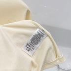 Pale yellow T-shirt with Burberry care label on the inner side near the hem