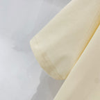 Pale yellow T-shirt fabric with stitched hem and side seam detail