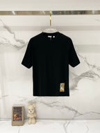Burberry black short-sleeve T-shirt on a clear hanger, crew neck and straight hem.