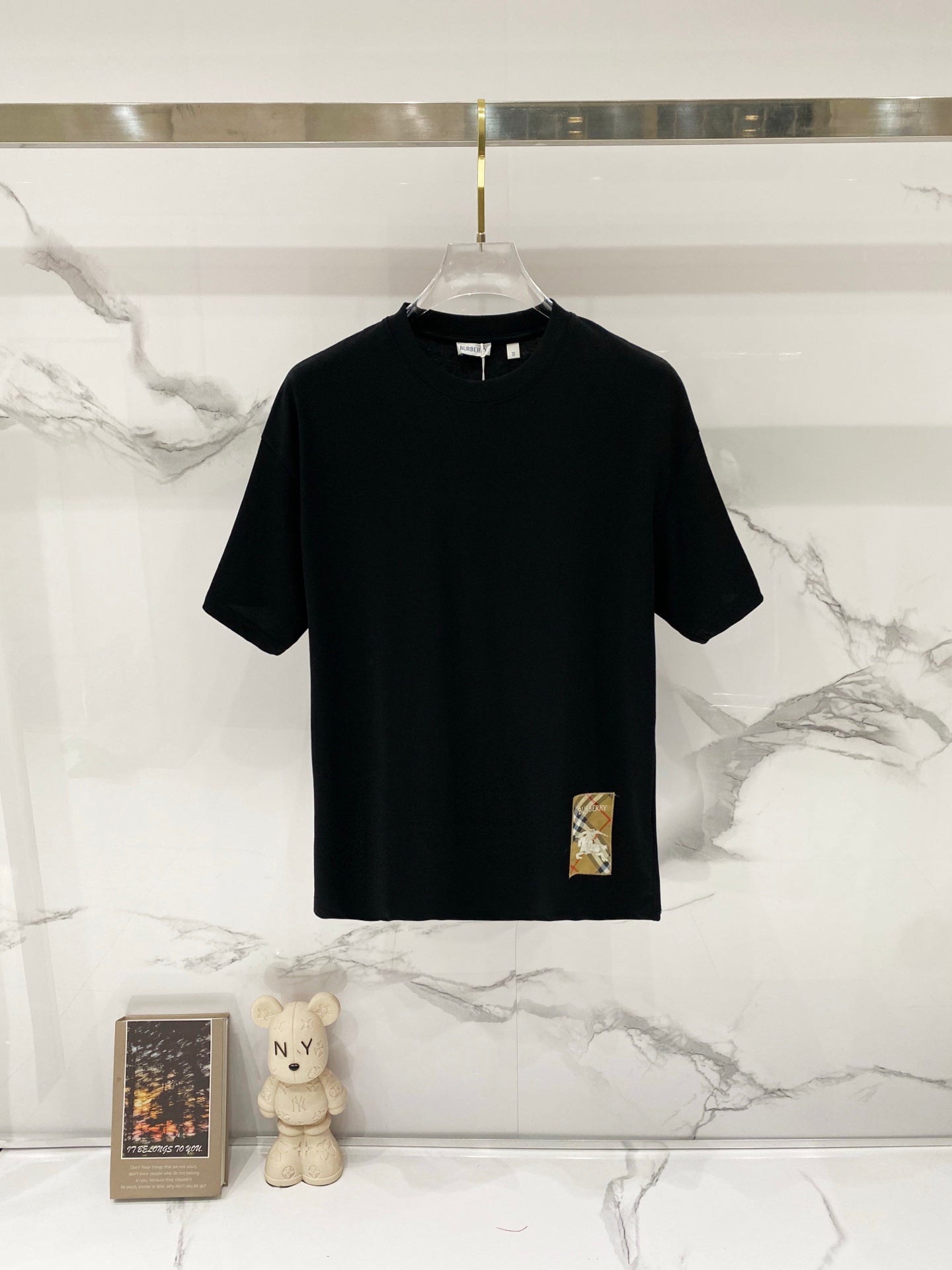 Burberry black short-sleeve T-shirt on a clear hanger, crew neck and straight hem.