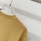 Tan crew-neck short-sleeve T-shirt with stitched shoulder seam