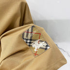 Tan short-sleeve T-shirt with embroidered horse-and-checkered back graphic
