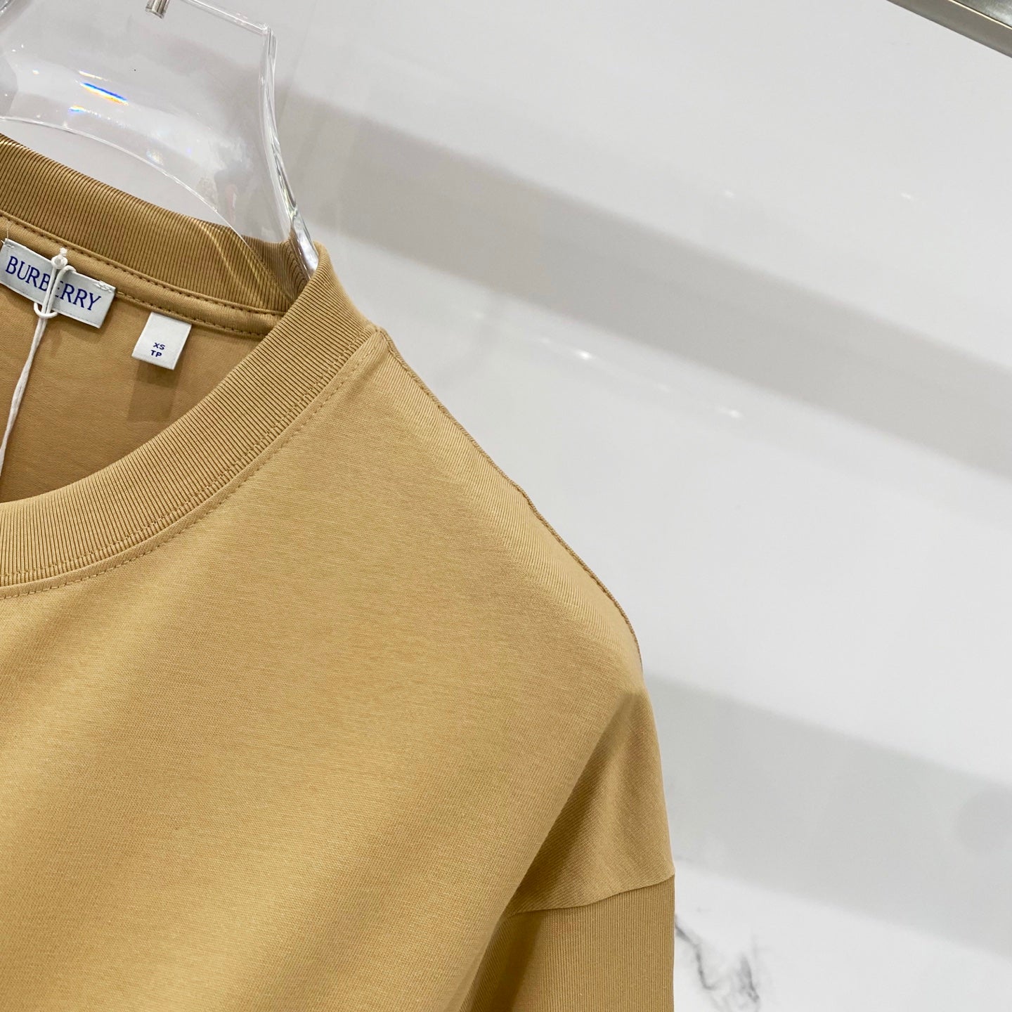 Tan short-sleeve T-shirt front side panel detail