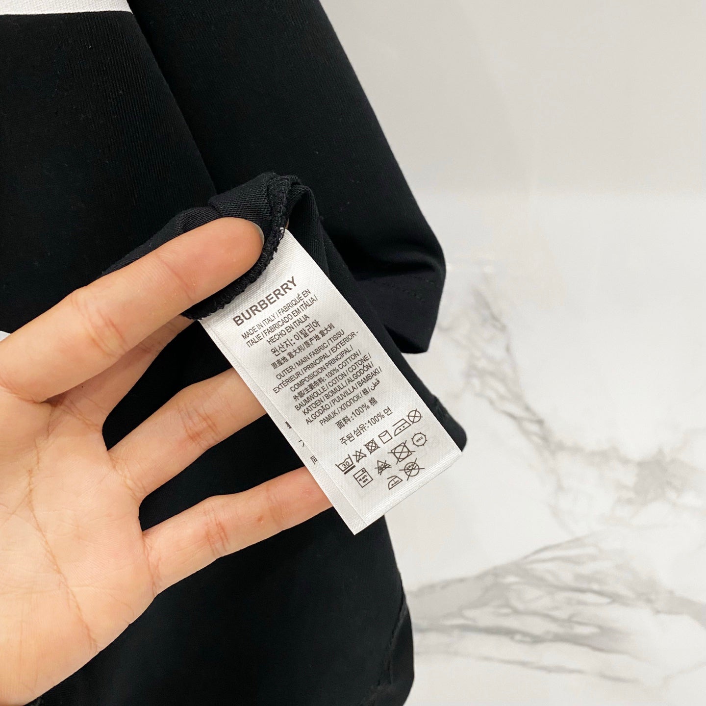 Black T-shirt fabric with white size and care label