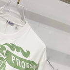 Kids white T-shirt close-up at shoulder and chest with green logo stripe print