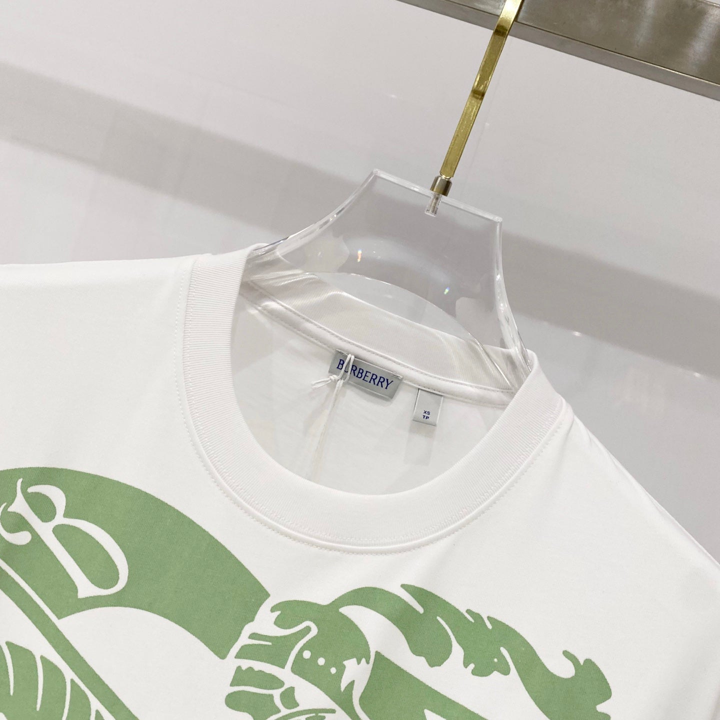 Kids white T-shirt neckline with green graphic print and Burberry neck label