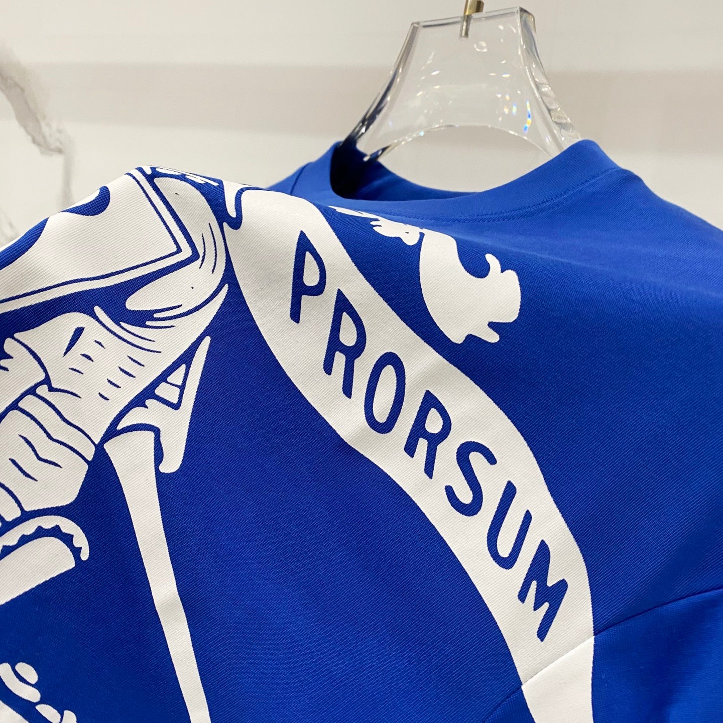 Blue short-sleeve T-shirt with white PRORSUM text across shoulder graphic