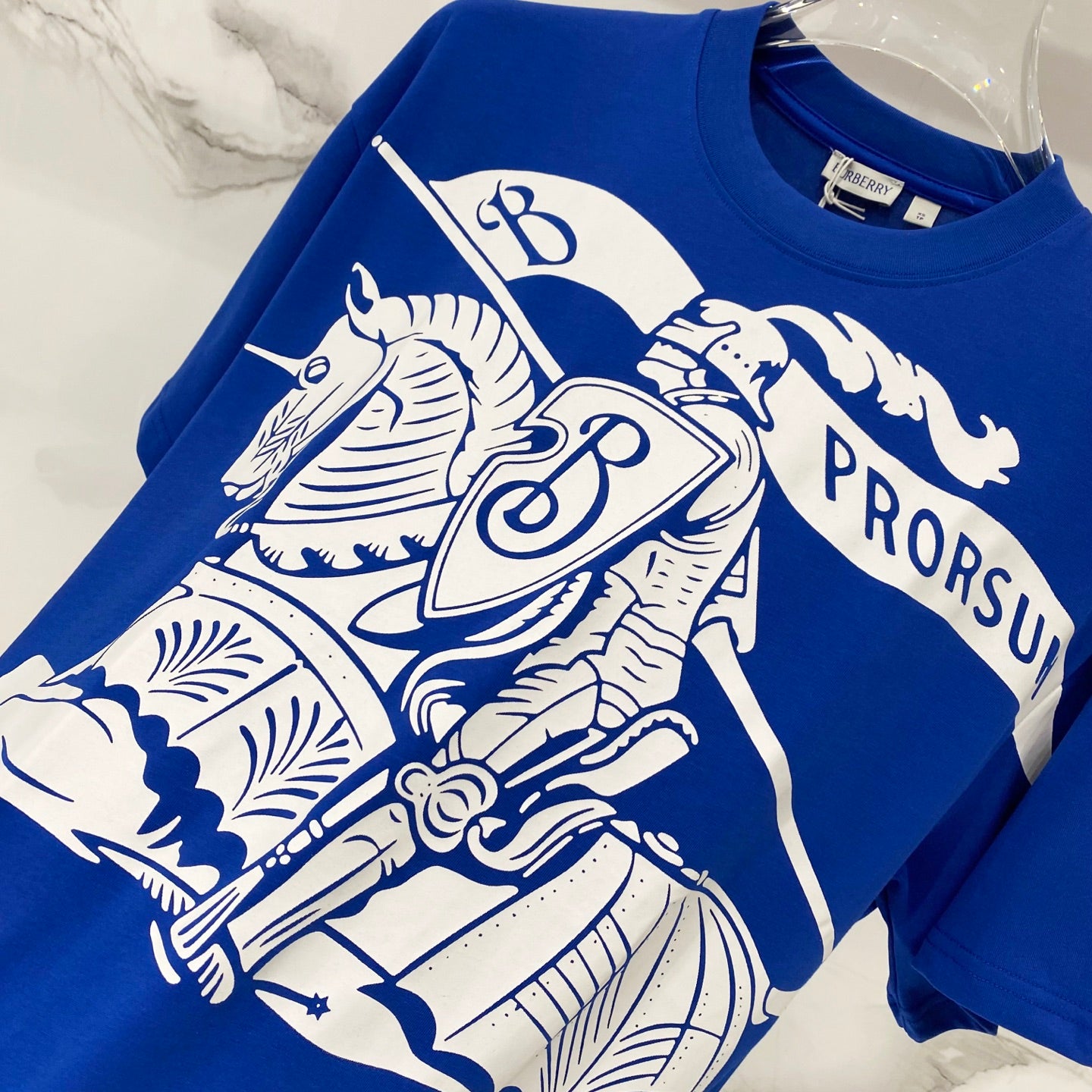 Blue short-sleeve T-shirt with ornate white animal and crest graphic print