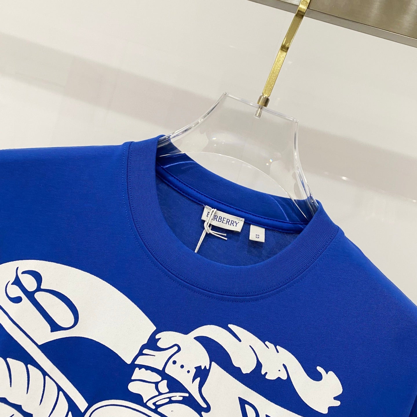 Blue crew-neck T-shirt neckline with Burberry label and partial white logo print