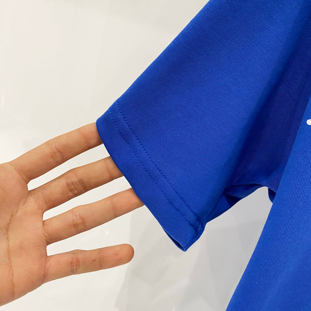 Blue cotton T-shirt fabric sleeve close-up with visible knit texture